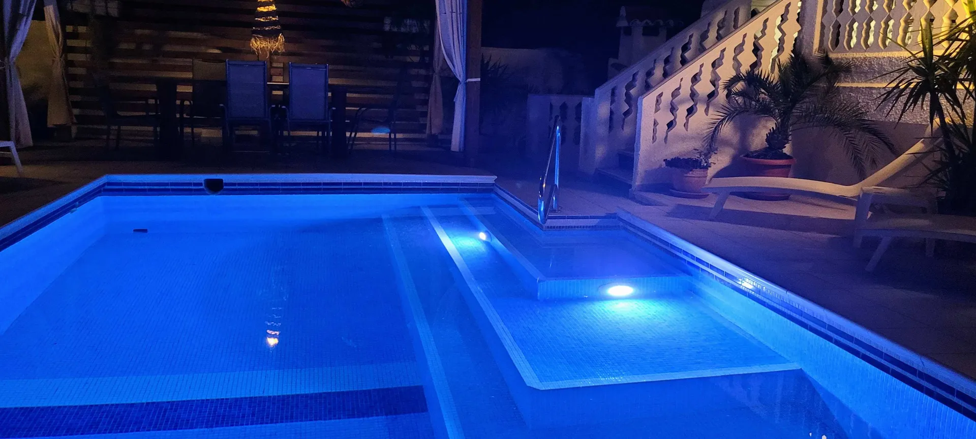 Pool at night with the new LED lighting installed during the 2025 renovation